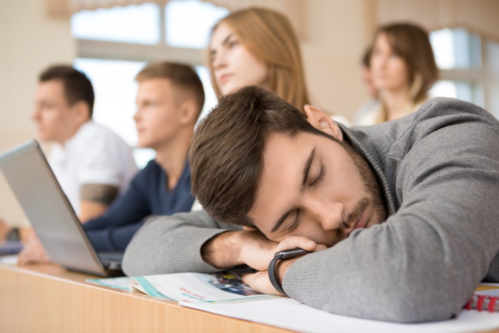 Male student sleeping in class